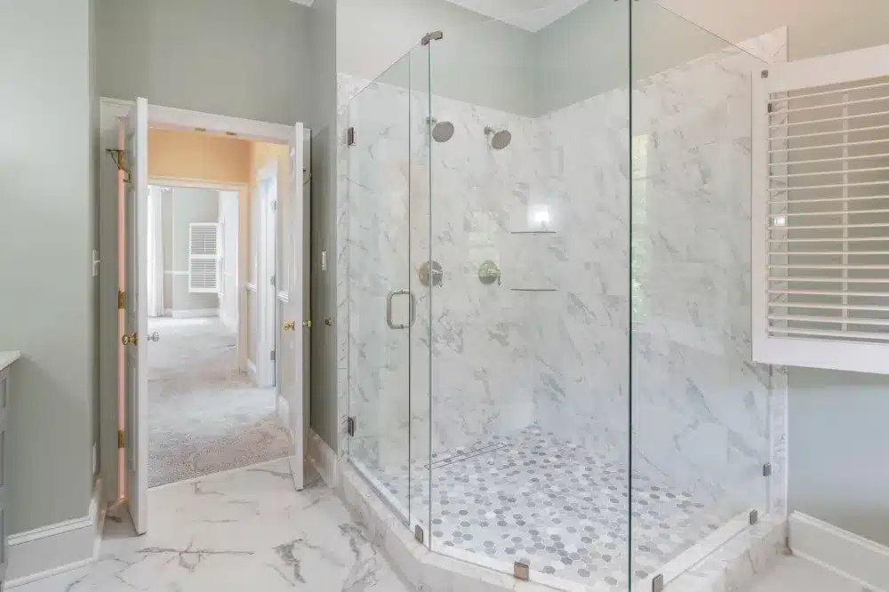 Renovated master bathroom with walk-in shower replacing old tub-shower combo in a Texas home