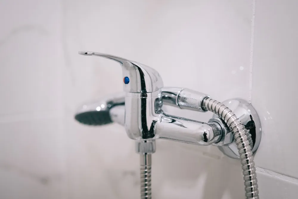 Plumber completing rough-in work during bathroom remodel requiring permit in Texas