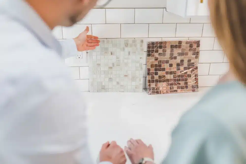 Homeowner comparing kitchen countertop material samples during a DFW home improvement project