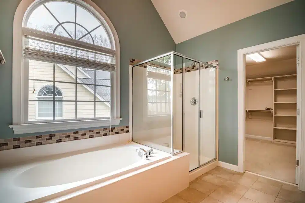 Walk-in shower tile installation during a bathroom remodel in a DFW area home