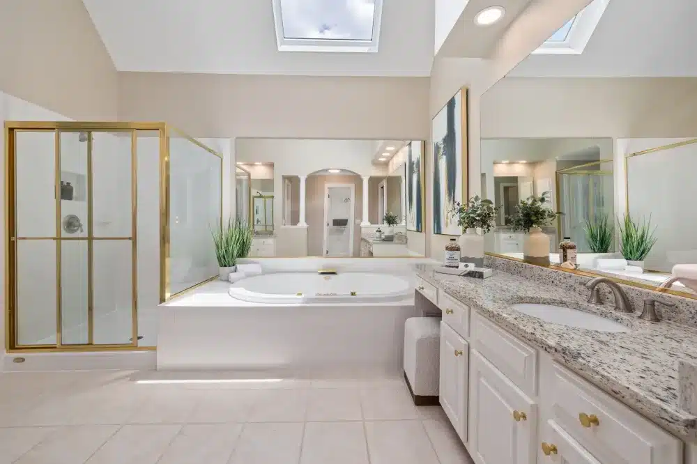 Bright finished bathroom renovation with frameless glass shower and double vanity in Texas home