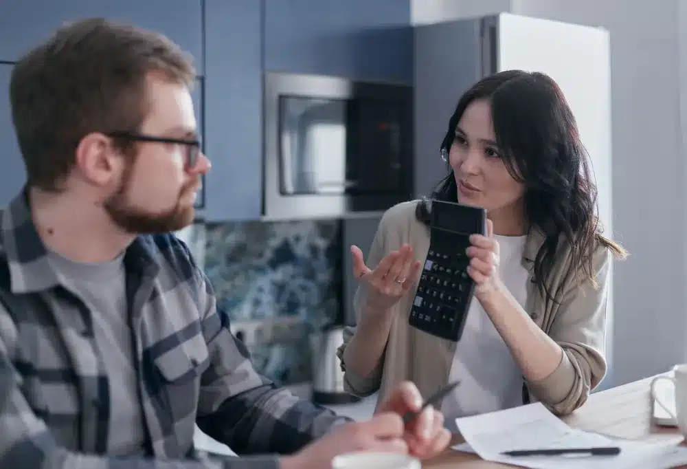 Contractor presenting a written remodeling estimate to homeowners during an in-home consultation