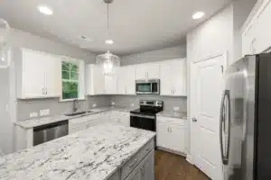 Bright open-concept kitchen remodel with white cabinets and quartz countertops in Arlington TX home