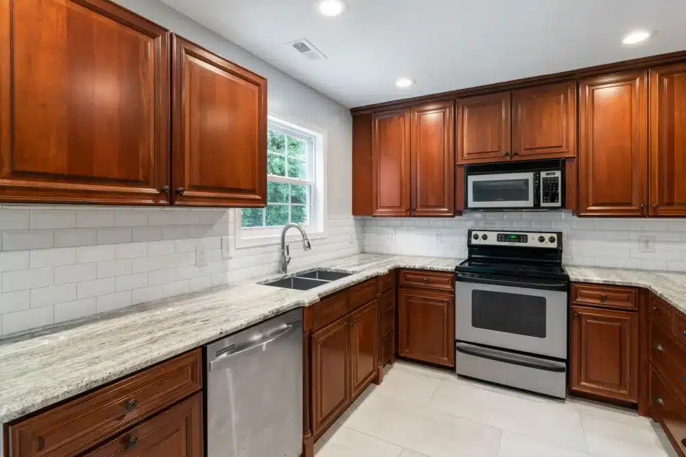 Fully remodeled modern kitchen with new flooring, backsplash, and stainless appliances in Arlington TX