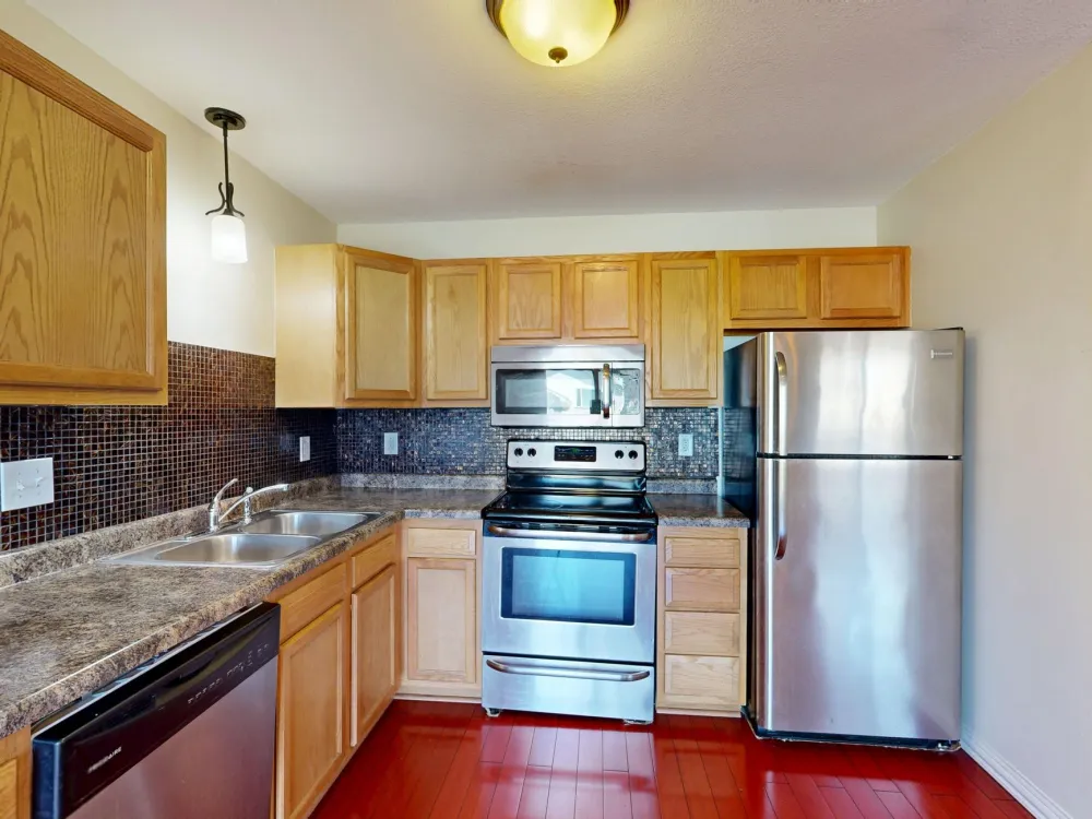 Contractor installing white shaker kitchen cabinets during Arlington TX kitchen remodel