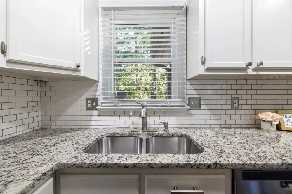 Subway tile backsplash installed in renovated Texas kitchen with stainless steel appliances