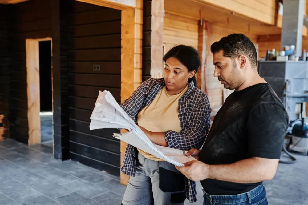 Remodeling contractor reviewing kitchen renovation plans with homeowner in Arlington Texas