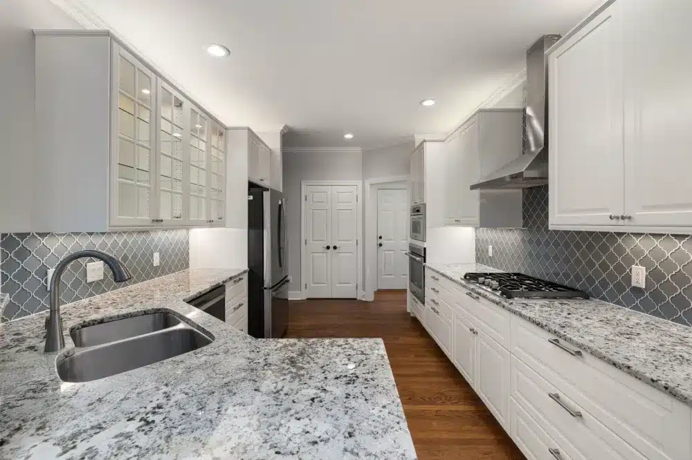 Freshly installed quartz countertop in a renovated Texas kitchen with subway tile backsplash