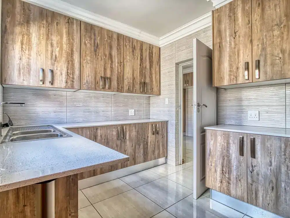 Contractor installing quartz countertop during a kitchen remodeling project in Bedford Texas