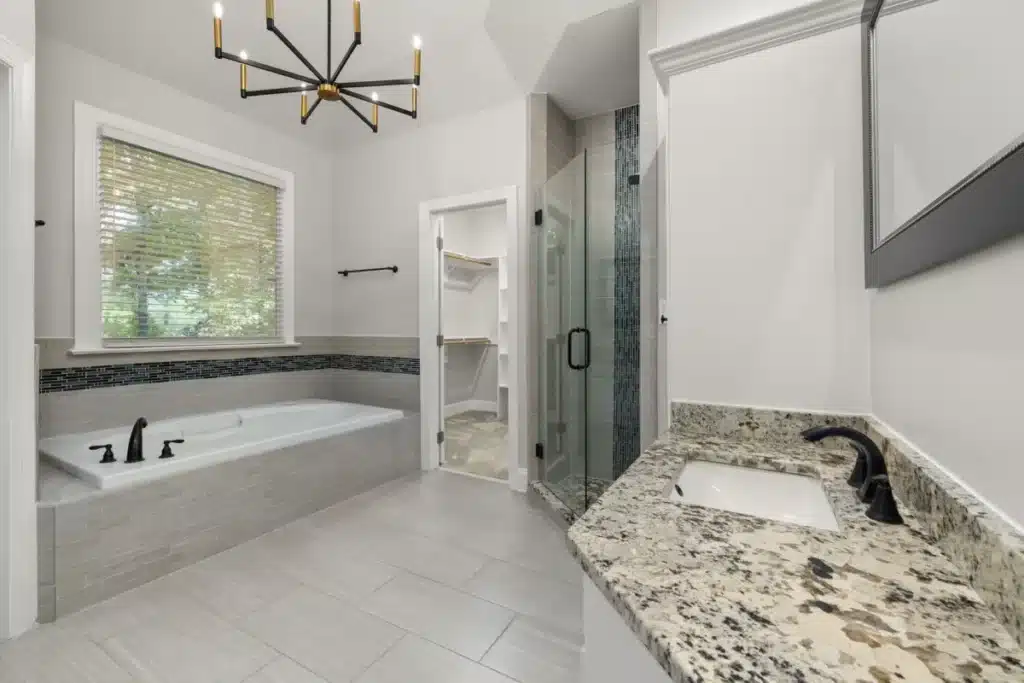 Bright modern master bathroom remodel with walk-in shower and double vanity in Hurst TX
