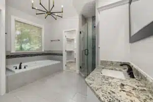 Bright modern master bathroom remodel with walk-in shower and double vanity in Hurst TX
