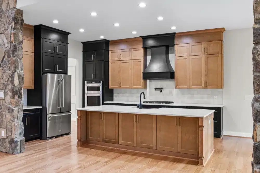 Waterfall quartz island in a modern Texas kitchen remodel with pendant lighting
