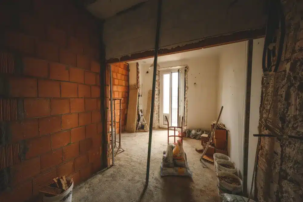 Contractor assessing load-bearing kitchen wall before open-concept remodel in Arlington Texas