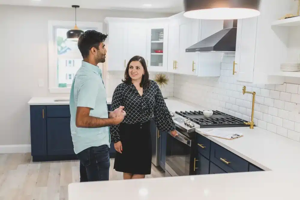 Homeowner meeting remodeling contractor to plan open-concept kitchen renovation in Arlington TX