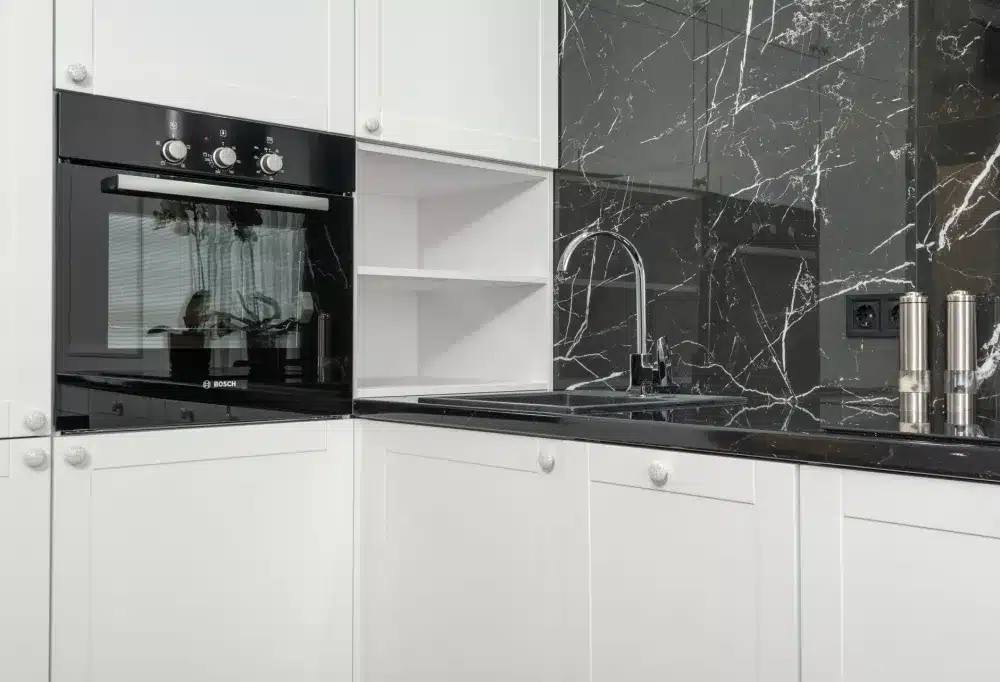Completed kitchen countertop and tile backsplash after a professional remodel in the DFW area