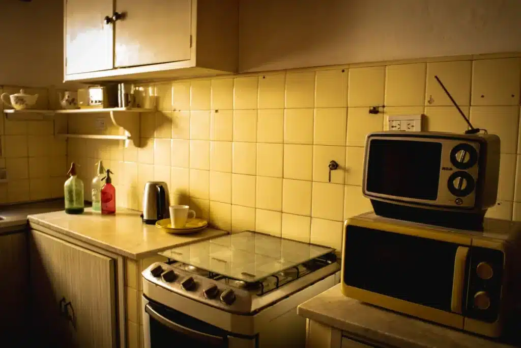 Retro-style kitchen remodel with bold color cabinets and quartz countertops in Arlington TX home