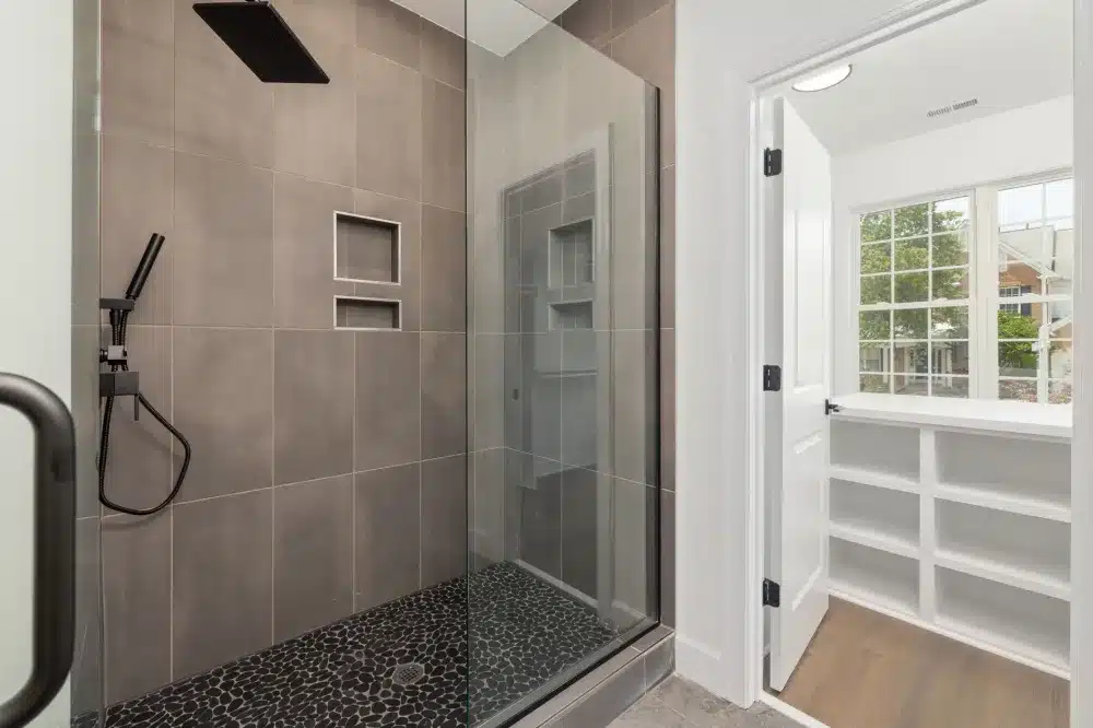 Modern walk-in shower with large format tile after bathroom remodel in Arlington Texas