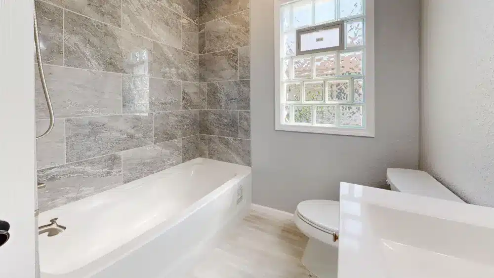 Licensed remodeling contractor installing fixtures during a bathroom renovation in Arlington Texas