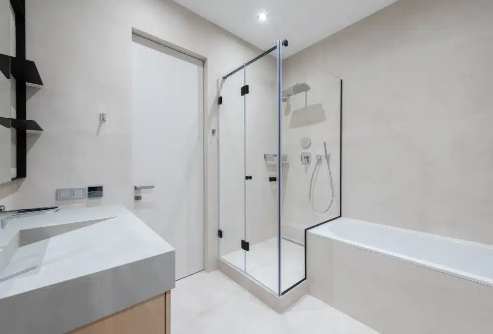 Frameless glass shower enclosure in a renovated master bathroom in Hurst Texas