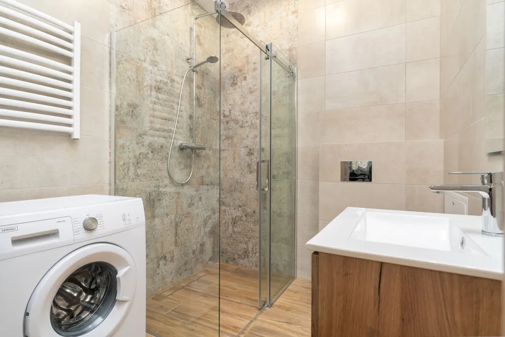Frameless glass shower enclosure with subway tile in a DFW home bathroom