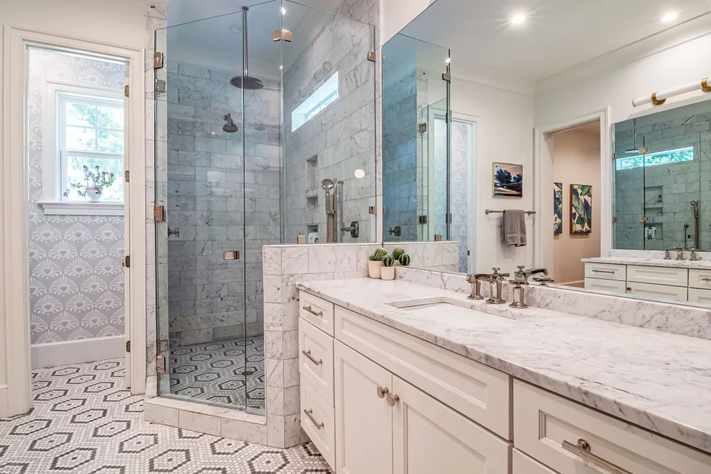 Finished custom walk-in shower with built-in niche and rainfall showerhead in Texas home