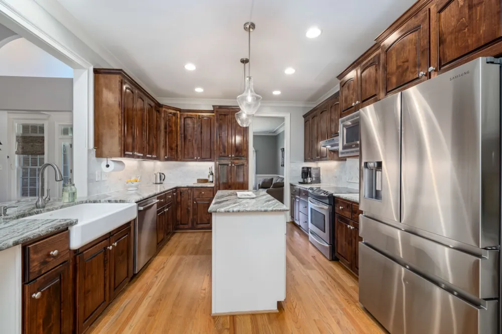 Kitchen island with a sink and seating in a remodeled Arlington kitchen