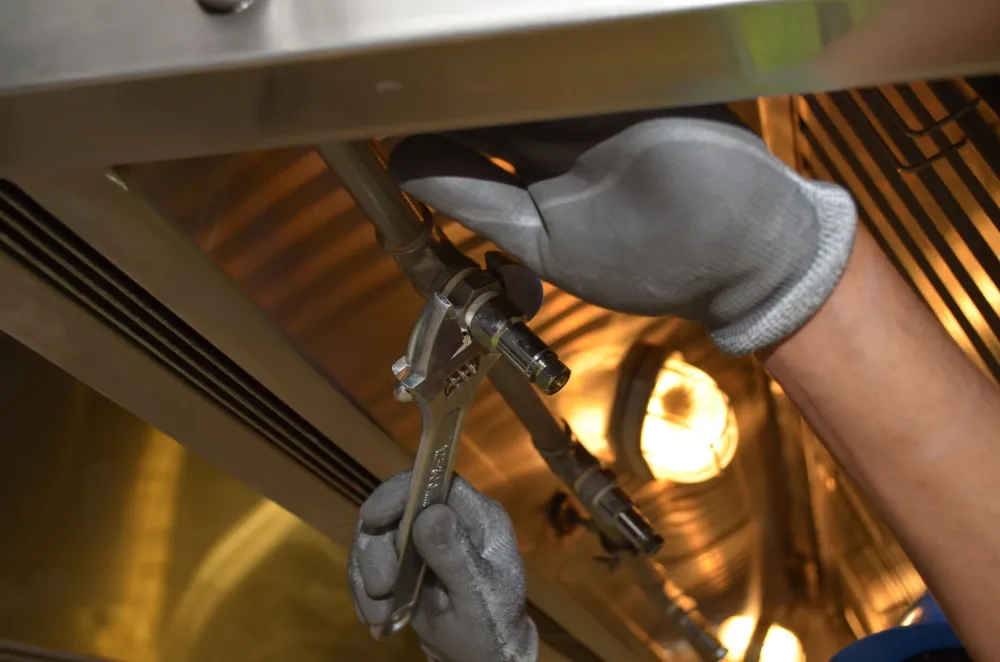 Plumber connecting new PVC drain lines for a kitchen island sink