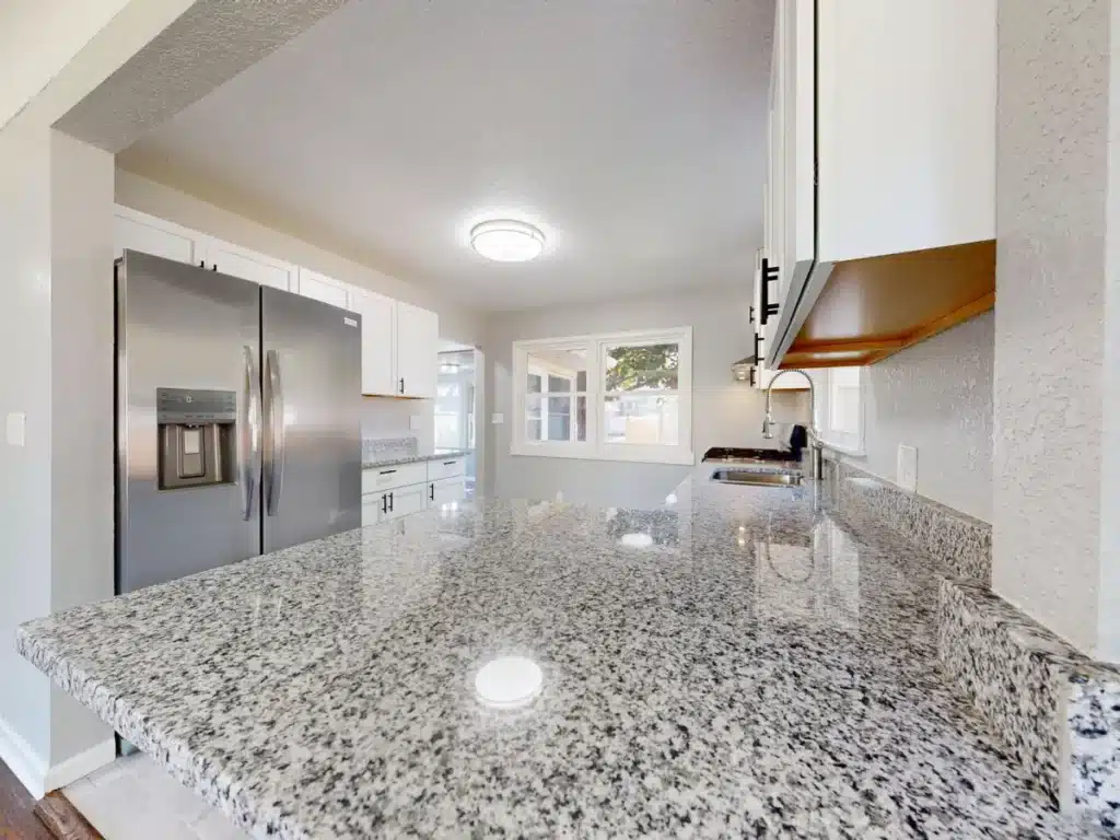Bright modern kitchen remodel with white shaker cabinets and quartz countertops in Arlington TX home