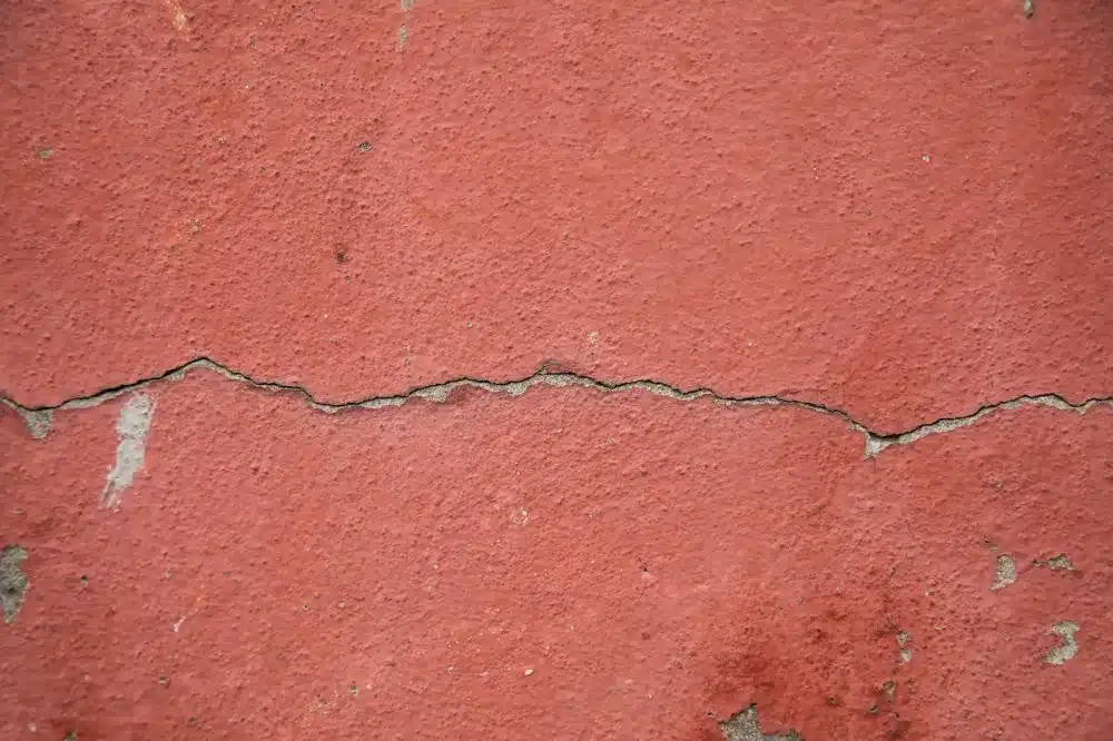 Stair-step crack in brick on an older home in Ash Meadows, Fort Worth
