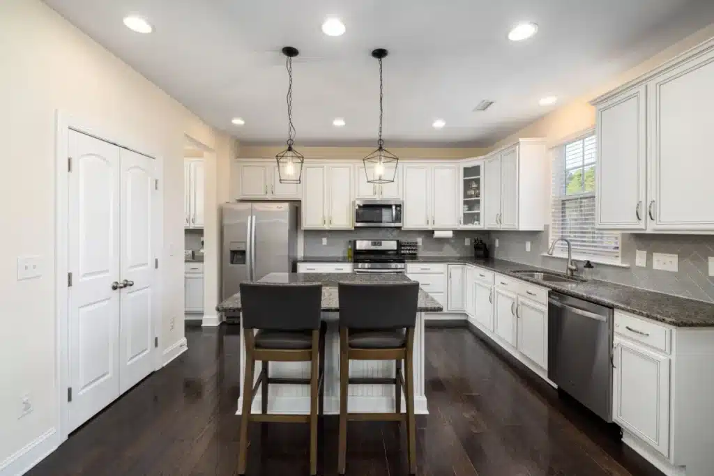 Remodeled kitchen with layered recessed and pendant lighting in a Fort Worth home