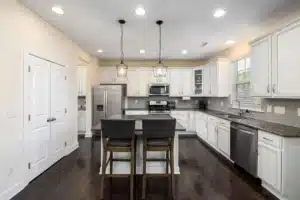 Remodeled kitchen with layered recessed and pendant lighting in a Fort Worth home