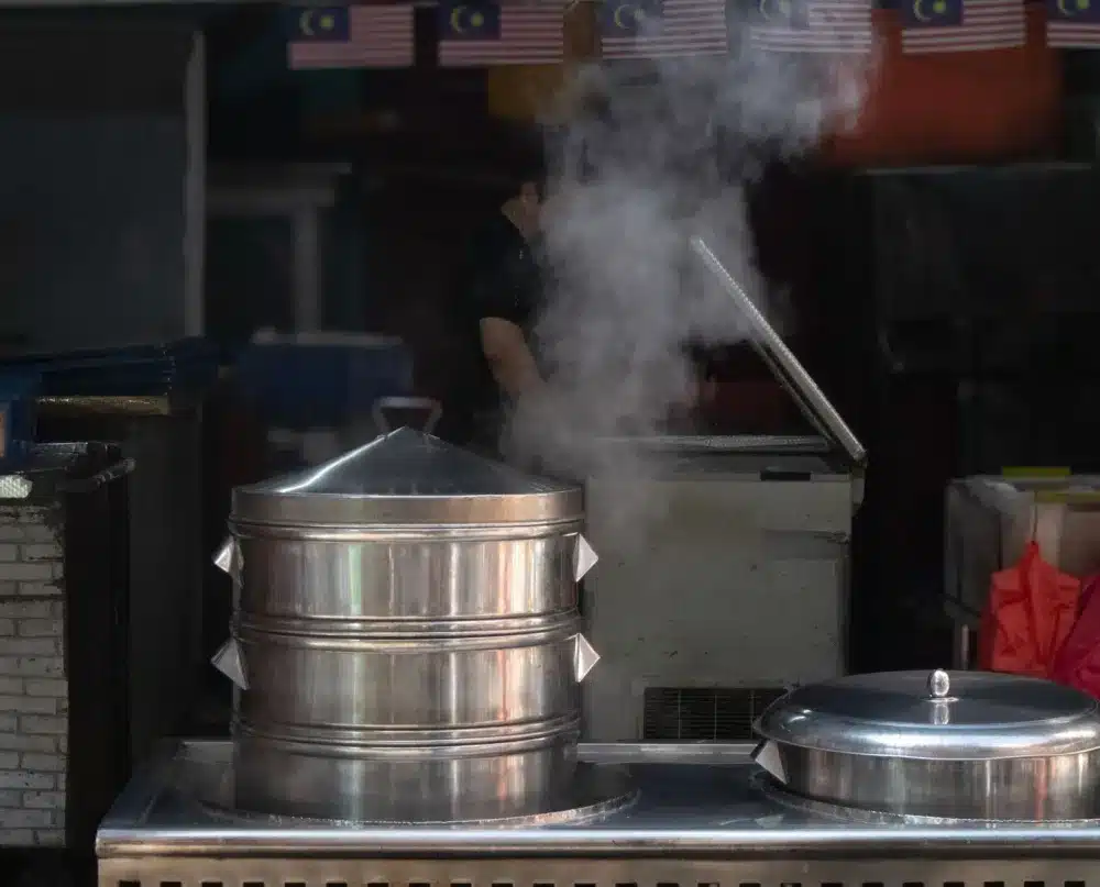 Steam rising from a pot under a range hood in a Dalworthington Gardens kitchen