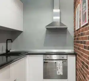 Kitchen with a ducted range hood over a gas cooktop in a Dalworthington Gardens home