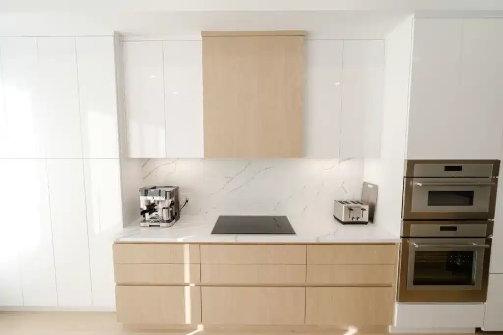 Bright modern kitchen remodel with two-tone cabinets and quartz countertops in Bedford TX home