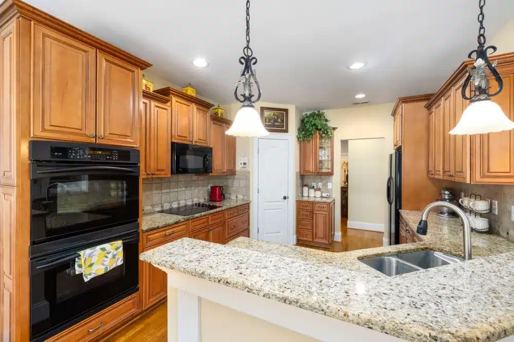 Contractor installing white quartz countertop in a budget kitchen remodel in Bedford Texas