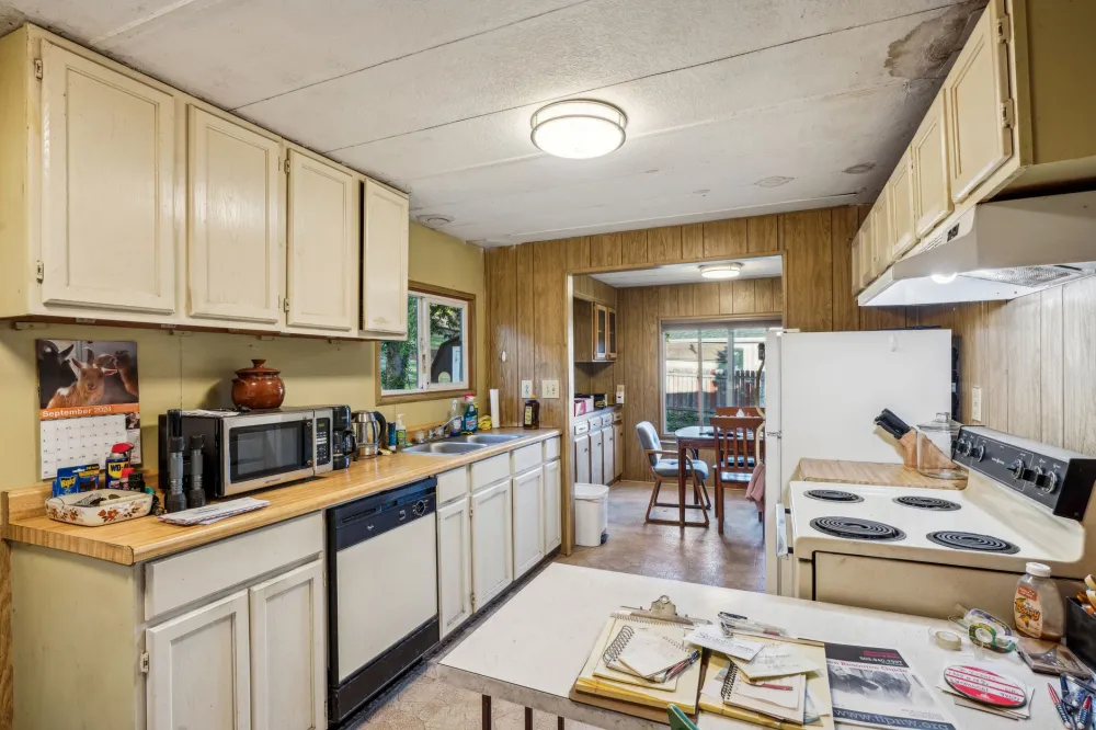 Boxed drywall soffit above original oak cabinets in an older Arlington kitchen