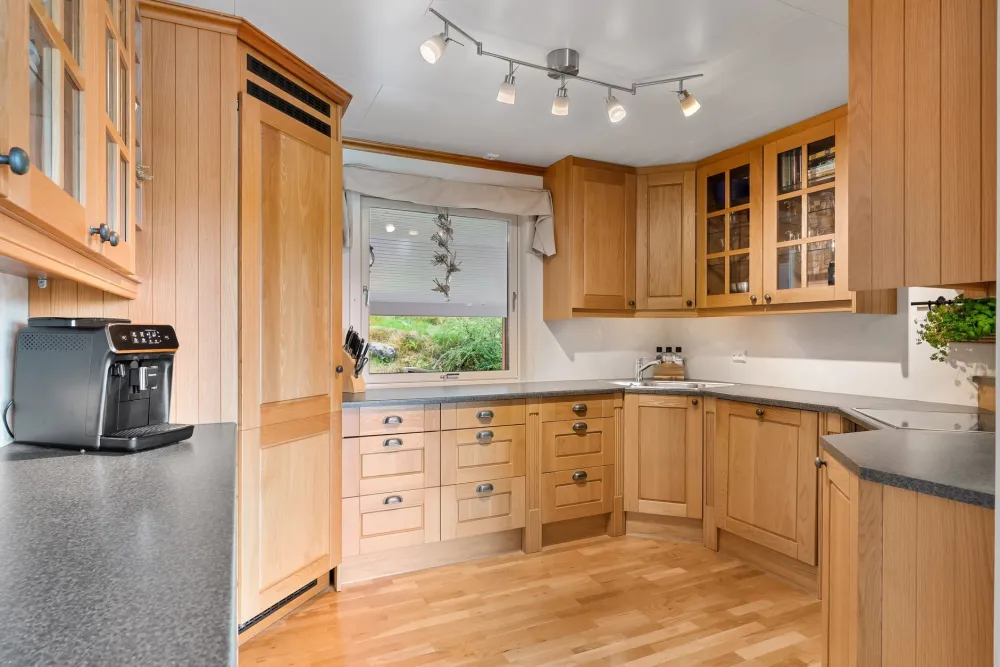 Installer setting tall upper cabinets to the ceiling in a kitchen remodel