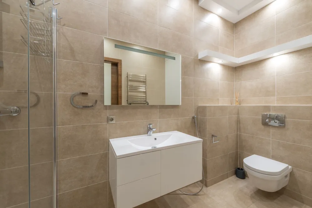 Matte porcelain and luxury vinyl plank samples for a humid Texas bathroom