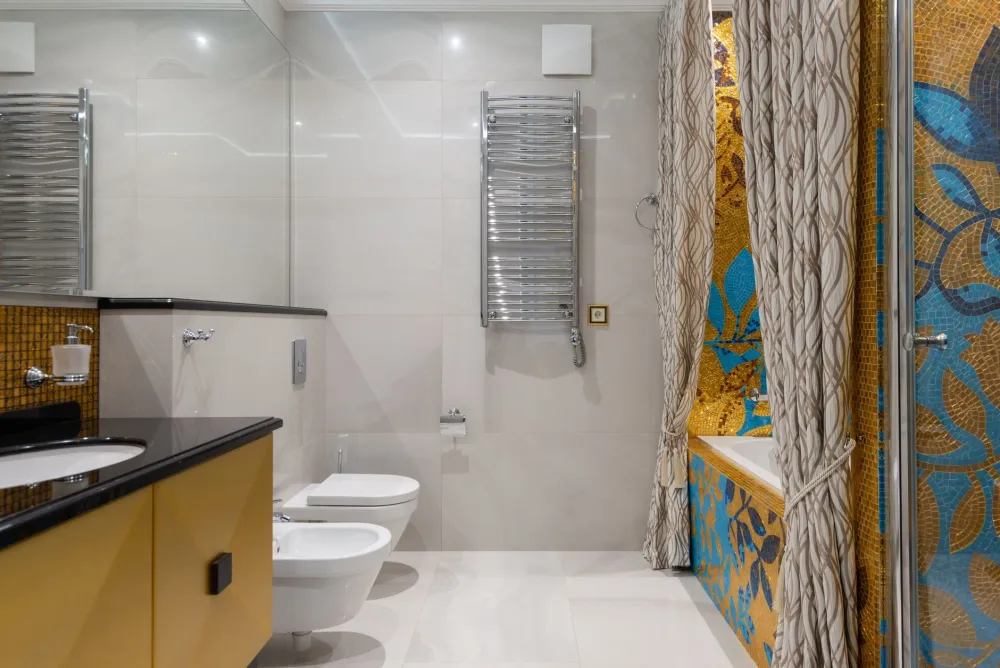 Mosaic shower floor tile sloped to the drain in an Arlington bathroom